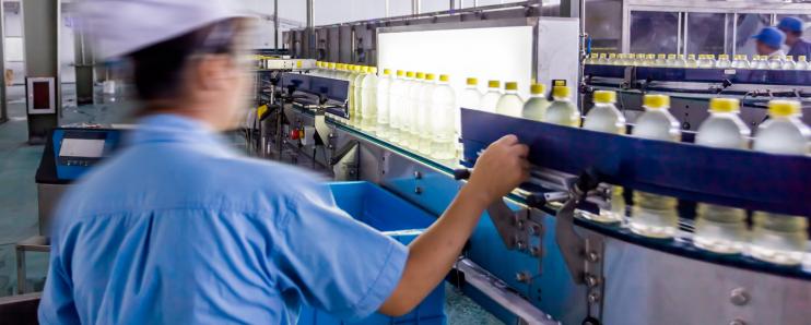 Man inspecting a factory floor automation line